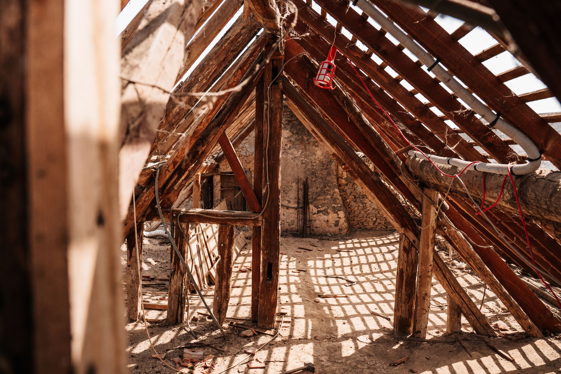 Wide view of older site-built roof rafters during renovation