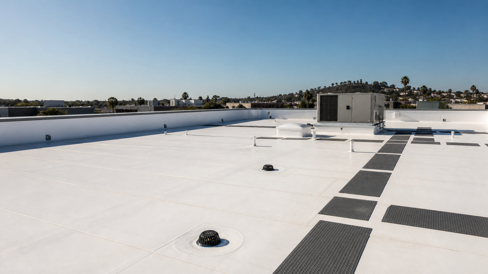 Completed white TPO roofing system on a low-slope building in San Diego
